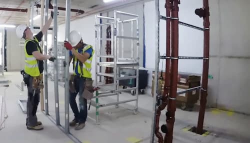 NVQ Level 2 dry liner fixers installing metal stud wall